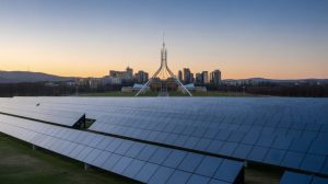 Canberra skyline with solar panels in the foreground, symbolising the ACT 100% renewable electricity policy.